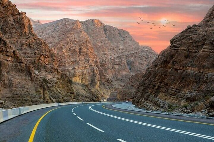 Winding through majestic mountains this scenic drive offers travelers a unique glimpse into the stunning landscapes of the UAE showcasing nature's beauty alongside modern adventure.